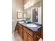 Bathroom features a double-sink vanity with dark countertops and wood cabinets at 700 N Dobson Rd # 54, Chandler, AZ 85224