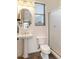 This simple bathroom features a pedestal sink, toilet, and glass enclosed shower at 700 N Dobson Rd # 54, Chandler, AZ 85224