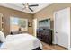 This bright bedroom has shuttered windows, a ceiling fan, and a wall-mounted television at 700 N Dobson Rd # 54, Chandler, AZ 85224