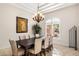 Dining room featuring a decorative chandelier, art, and a large window at 700 N Dobson Rd # 54, Chandler, AZ 85224