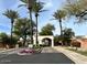 Community entrance with archway, palm trees and lush landscaping providing an inviting and grand welcome at 700 N Dobson Rd # 54, Chandler, AZ 85224