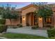 Charming single-story home boasts meticulous landscaping and a welcoming arched entryway beneath a colorful twilight sky at 700 N Dobson Rd # 54, Chandler, AZ 85224