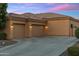 Spacious three-car garage with tasteful exterior lighting and a paved driveway at 700 N Dobson Rd # 54, Chandler, AZ 85224