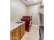 Bright laundry room with a utility sink, cabinets, countertop space, and a sleek red washer/dryer at 700 N Dobson Rd # 54, Chandler, AZ 85224