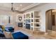 The living room features custom built-ins, a fireplace, a ceiling fan, and comfortable blue couches at 700 N Dobson Rd # 54, Chandler, AZ 85224