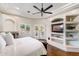 This main bedroom features built-in shelves, wood floors, and access to outdoor patio at 700 N Dobson Rd # 54, Chandler, AZ 85224