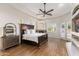 Bright main bedroom features wood floors, ceiling fan, fireplace, and access to outdoor area at 700 N Dobson Rd # 54, Chandler, AZ 85224