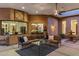 Comfortable outdoor seating area with a fireplace, fountain, and view into the adjacent dining and living spaces at 700 N Dobson Rd # 54, Chandler, AZ 85224