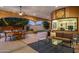 Inviting covered patio with elegant dining and seating areas overlooks a well-manicured lawn at 700 N Dobson Rd # 54, Chandler, AZ 85224