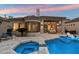 A backyard oasis featuring a pool, spa, and covered patio with stylish outdoor furniture and a unique rounded architecture at 7705 E Doubletree Ranch Rd # 51, Scottsdale, AZ 85258