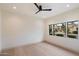Bright bedroom with hardwood floors, fresh paint, and a large window with backyard views at 7705 E Doubletree Ranch Rd # 51, Scottsdale, AZ 85258