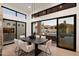 Elegant dining area with modern table and seating, connected to a spacious living room and kitchen with a view of the pool at 7705 E Doubletree Ranch Rd # 51, Scottsdale, AZ 85258