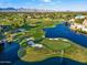 Aerial view of lush golf course with water features and mountain views in a resort community on a sunny day at 7705 E Doubletree Ranch Rd # 51, Scottsdale, AZ 85258