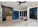 Modern primary bedroom with a view of the pool, sleek ceiling fan, hardwood floors, and comfortable seating area at 7705 E Doubletree Ranch Rd # 51, Scottsdale, AZ 85258