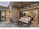 Stylish outdoor patio featuring a cozy seating area, stone floors, and seamless indoor-outdoor living with sliding glass doors at 7705 E Doubletree Ranch Rd # 51, Scottsdale, AZ 85258