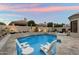 Backyard pool with in-pool seating, a spa, fire features, lush landscaping, and desert sunset at 7705 E Doubletree Ranch Rd # 51, Scottsdale, AZ 85258