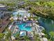 Aerial view of luxury resort-style pool and lounge areas with palm trees and water features on a sunny day at 7705 E Doubletree Ranch Rd # 51, Scottsdale, AZ 85258