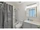 Well-lit bathroom with a shower/tub combo and vanity with storage at 7765 W Glenn Dr, Glendale, AZ 85303