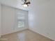 Bedroom with tile flooring, ceiling fan, and lots of natural light from the window at 7765 W Glenn Dr, Glendale, AZ 85303