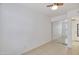 Bright bedroom boasts tile flooring, a ceiling fan, and mirrored closet doors at 7765 W Glenn Dr, Glendale, AZ 85303
