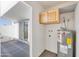 Bright laundry area with upper cabinets, washer/dryer hookups, and access to the outdoor patio at 7765 W Glenn Dr, Glendale, AZ 85303