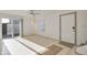 Open living space with tile floors, a sliding glass door, ceiling fan, and a staircase in view at 7765 W Glenn Dr, Glendale, AZ 85303