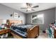 A cozy bedroom with a ceiling fan and a window that provides natural light at 7908 W Rose Garden Ln, Peoria, AZ 85382