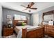 This is a bedroom with a bed and dresser set. The bedroom has a ceiling fan and a window at 7908 W Rose Garden Ln, Peoria, AZ 85382