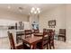 Cozy dining area with tile flooring, table and chairs, and open to the kitchen at 7908 W Rose Garden Ln, Peoria, AZ 85382