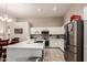 Bright kitchen features white cabinets, stainless steel appliances, and a large island with quartz countertops at 7908 W Rose Garden Ln, Peoria, AZ 85382