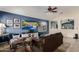 Inviting living room featuring tile flooring, sofa, ceiling fan and large entertainment center at 7908 W Rose Garden Ln, Peoria, AZ 85382