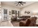 Comfortable living room with plush seating, tile flooring, and bright natural light at 7908 W Rose Garden Ln, Peoria, AZ 85382