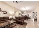 Open-concept living room with a sofa, tile flooring, and direct access to the kitchen at 7908 W Rose Garden Ln, Peoria, AZ 85382