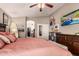 This main bedroom features a ceiling fan, natural light, and beach themed decor at 7908 W Rose Garden Ln, Peoria, AZ 85382