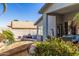 Relaxing outdoor patio area with a refreshing pool, comfortable seating, and colorful flowering bushes at 7908 W Rose Garden Ln, Peoria, AZ 85382