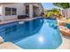 Beautiful pool featuring rock details, landscaping, and a covered patio with seating for outdoor living at 7908 W Rose Garden Ln, Peoria, AZ 85382