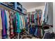 Organized walk-in closet with ample hanging space, shoe racks, and shelving at 7908 W Rose Garden Ln, Peoria, AZ 85382