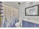 Bathroom featuring a single sink vanity and a bathtub with a patterned shower curtain at 8137 W Wood Dr, Peoria, AZ 85381