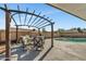 Outdoor dining with cushioned chairs under a shaded pergola next to in-ground pool at 8137 W Wood Dr, Peoria, AZ 85381