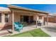 Covered patio with an outdoor seating area, next to a putting green and fire pit at 8535 W Willow Ave, Peoria, AZ 85381