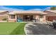 Backyard features a covered patio, putting green, and fire pit with seating at 8535 W Willow Ave, Peoria, AZ 85381