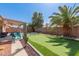 Backyard with a covered patio, an artificial turf putting green, and desert landscaping at 8535 W Willow Ave, Peoria, AZ 85381
