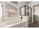 Bright bathroom featuring a soaking tub and a modern glass-enclosed shower at 8535 W Willow Ave, Peoria, AZ 85381