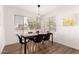 Cozy dining room features natural light from backyard views, a modern light fixture and seating for six at 8535 W Willow Ave, Peoria, AZ 85381