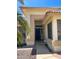 Close-up of the front entrance of a charming home with a 'HOME' sign and desert landscaping at 8535 W Willow Ave, Peoria, AZ 85381
