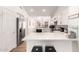 Open concept kitchen with stainless steel appliances, white cabinets and quartz countertops at 8535 W Willow Ave, Peoria, AZ 85381