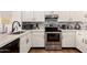 Modern kitchen with stainless steel oven, quartz countertops and tile backsplash at 8535 W Willow Ave, Peoria, AZ 85381