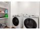 A laundry room featuring modern appliances and storage shelves at 8535 W Willow Ave, Peoria, AZ 85381