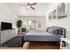 Comfortable main bedroom features a large bay window, ceiling fan and wood-look floors at 8535 W Willow Ave, Peoria, AZ 85381