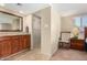 Bathroom featuring double vanity with granite countertops and a walk-in closet access at 9340 N 92Nd St # 120, Scottsdale, AZ 85258